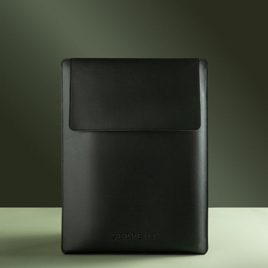 Black laptop sleeve with SERPENT logo against green background 