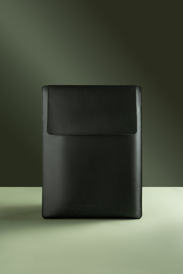 Black laptop sleeve with SERPENT logo against green background 