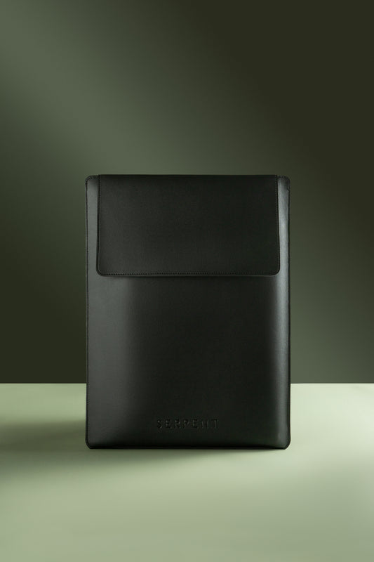 Black laptop sleeve with SERPENT logo against green background 