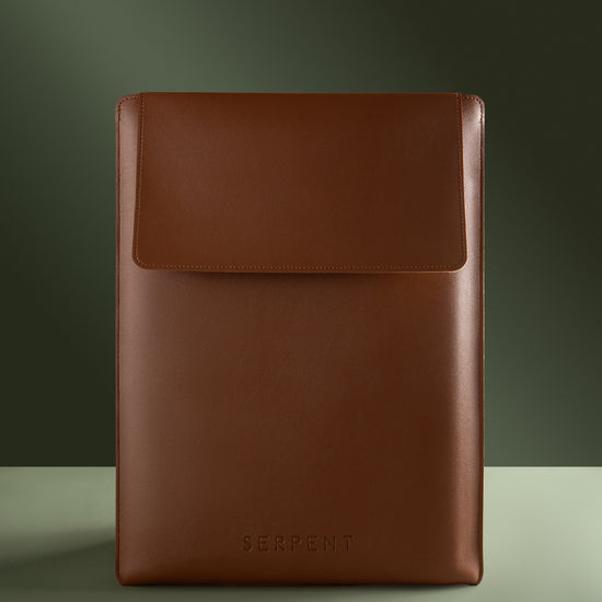 Brown leather sleeve with 'SERPENT' branding on a green background