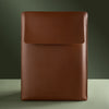 Brown leather sleeve with 'SERPENT' branding on a green background