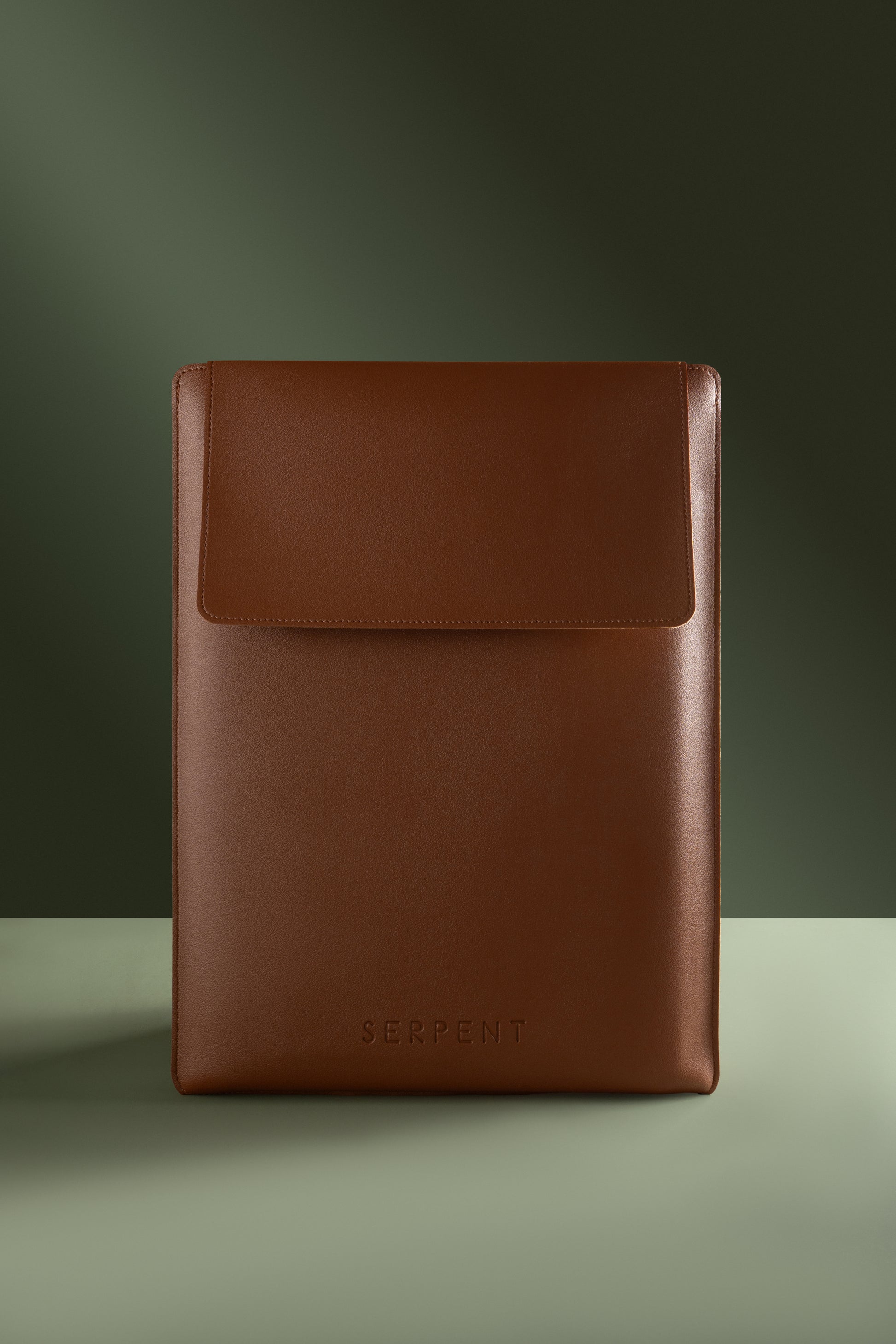 Brown leather sleeve with 'SERPENT' branding on a green background