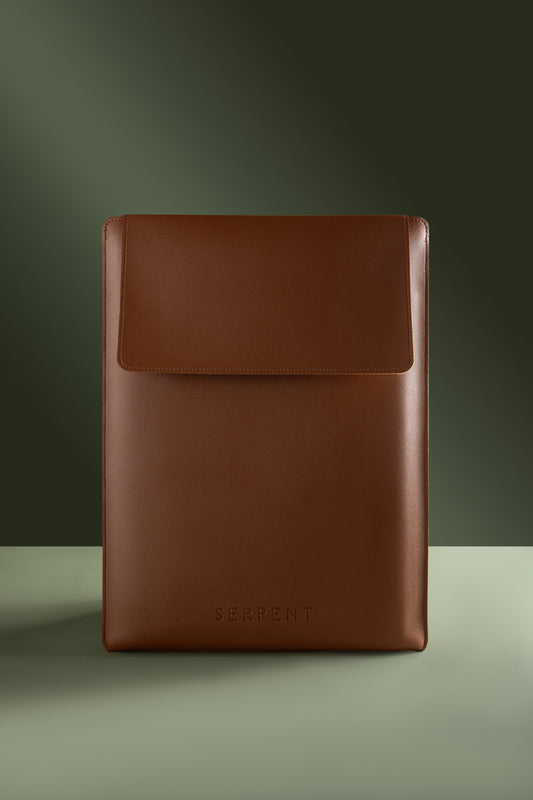 Brown leather sleeve with 'SERPENT' branding on a green background